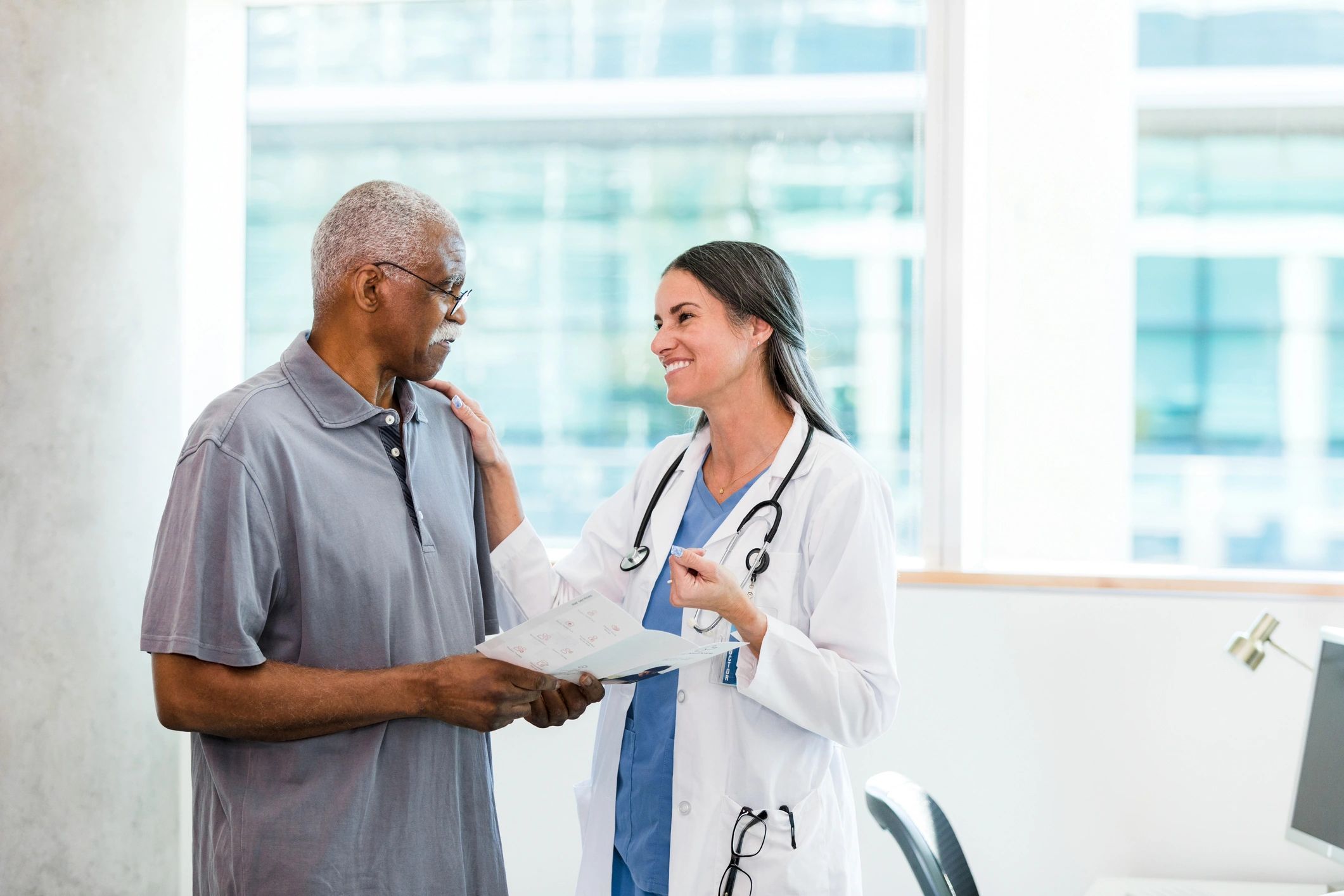 Doctor providing compassionate support to an older patient