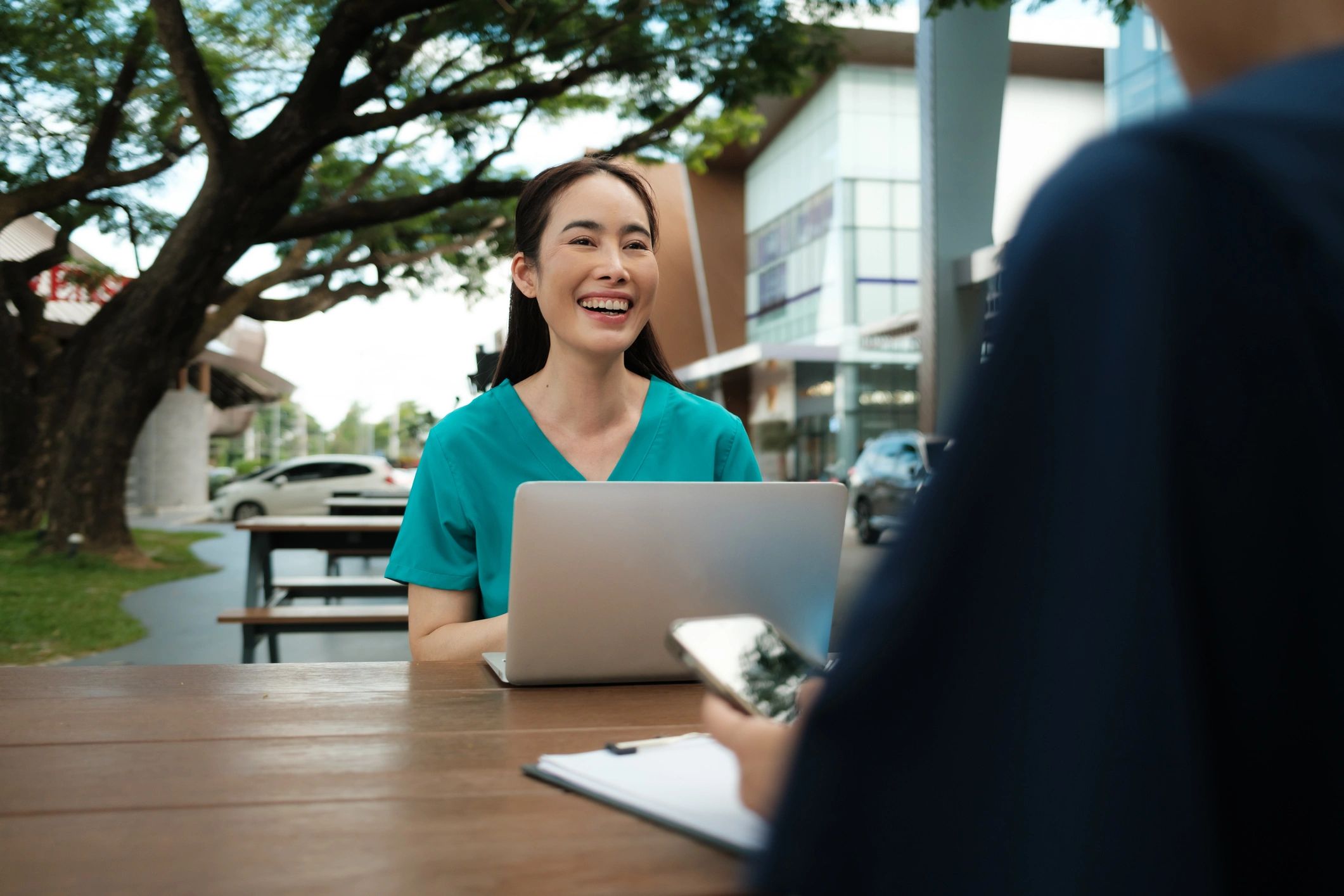 Healthcare clinician using a laptop during a consultation